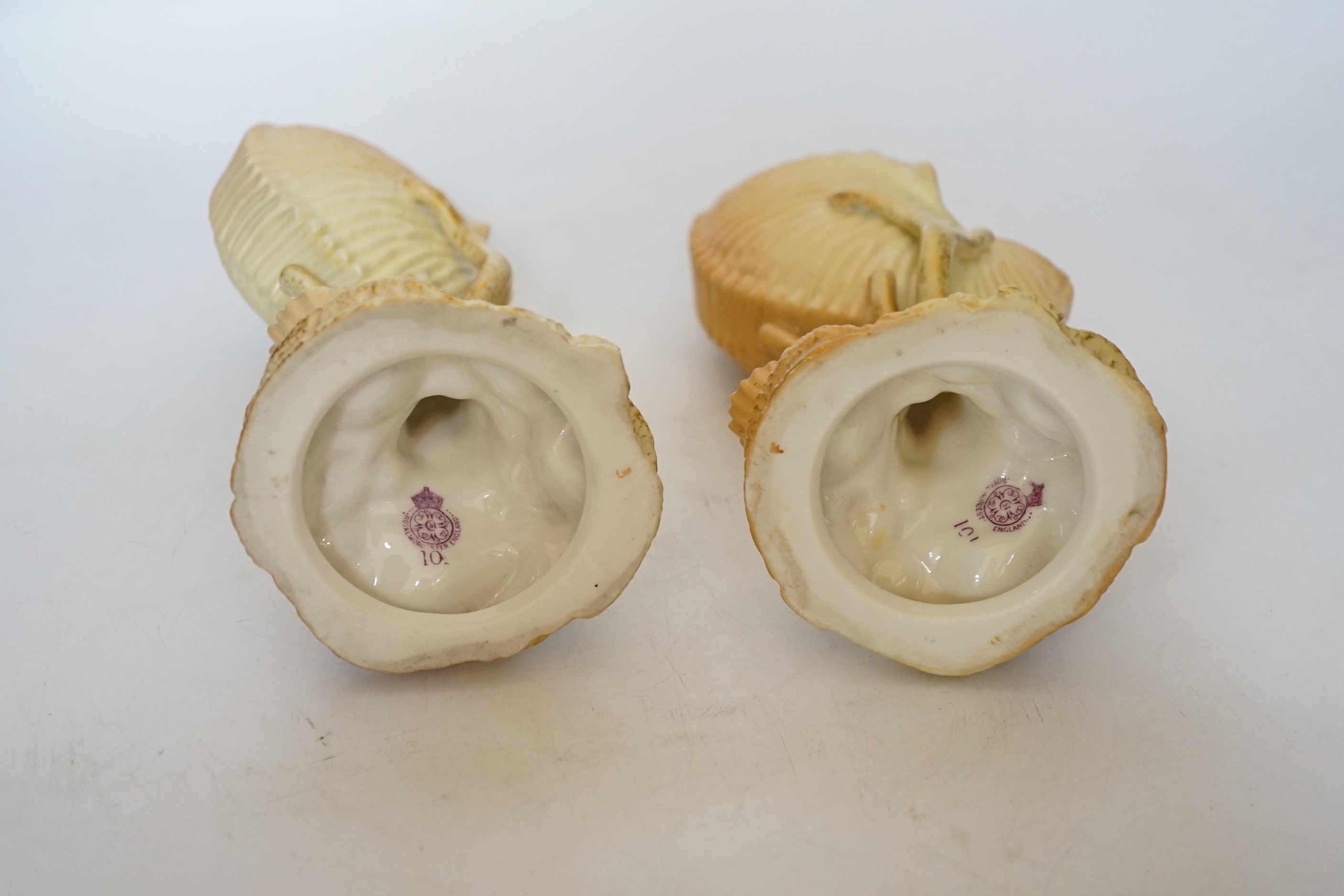 A pair of Royal Worcester blush ivory nautilus shell spill vases, 17cm